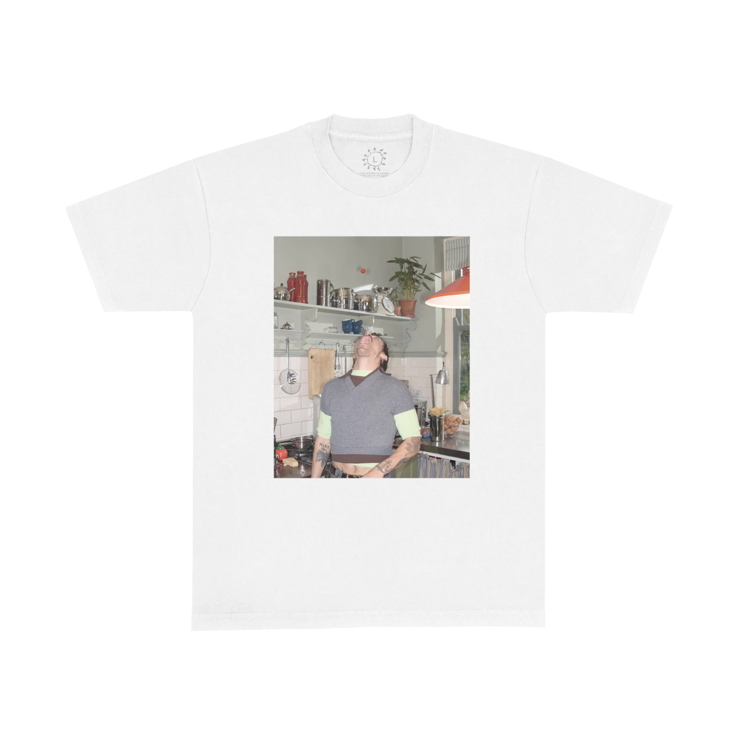 White Harry Styles t shirt featuring playful kitchen photo graphic with Harry balancing a tomato, inspired by Harry’s House era photography and vintage home aesthetic
