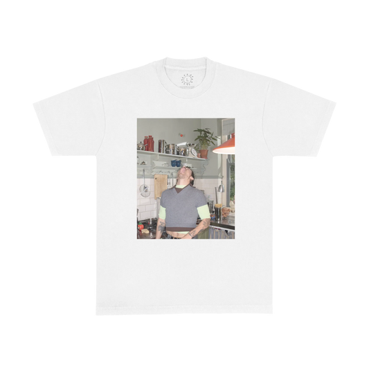 White Harry Styles t shirt featuring playful kitchen photo graphic with Harry balancing a tomato, inspired by Harry’s House era photography and vintage home aesthetic