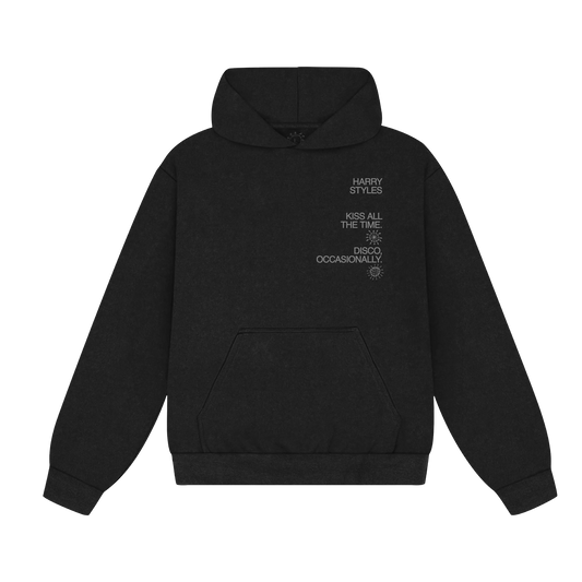Front view of black Harry Styles hoodie featuring Kiss All The Time Disco Occasionally text graphic with relaxed fit, kangaroo pocket, and premium heavyweight fabric